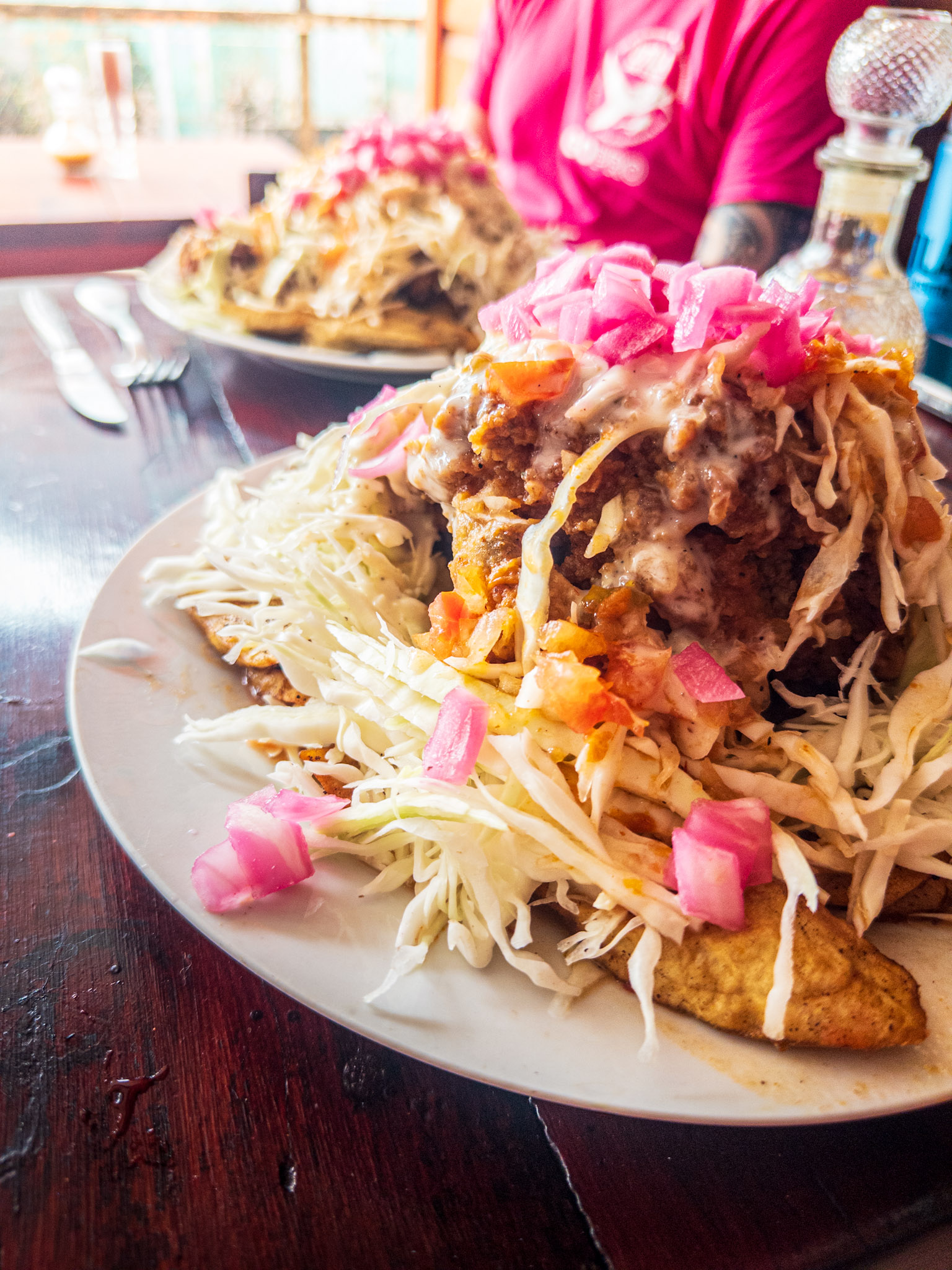 Overflowing dish of pollo chucho at a restaurant in Utila