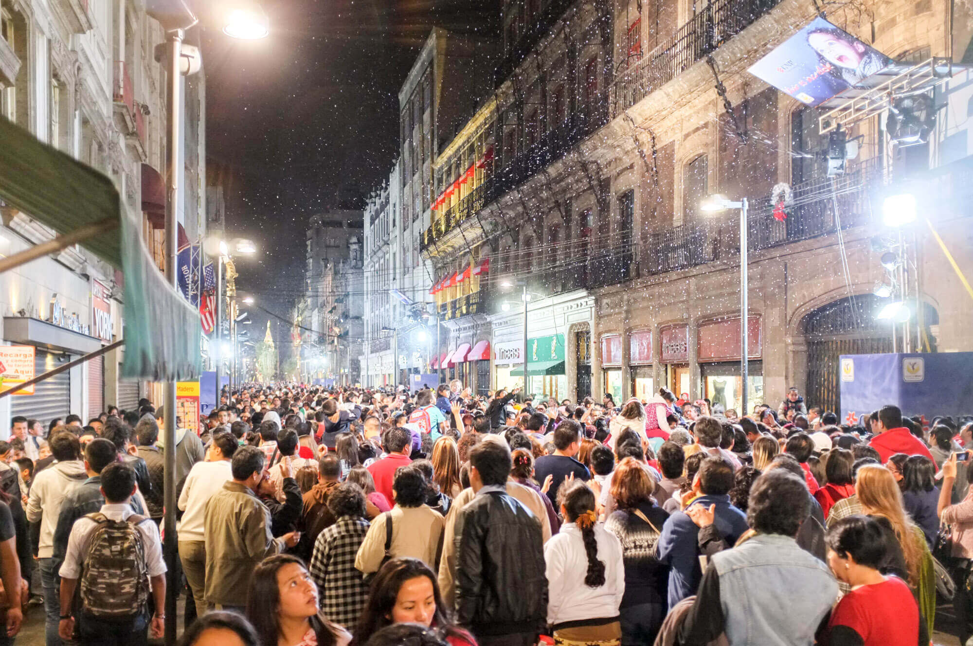 A crowded evening Calle Madero in Mexico City with fake snow to celebrate Christmas
