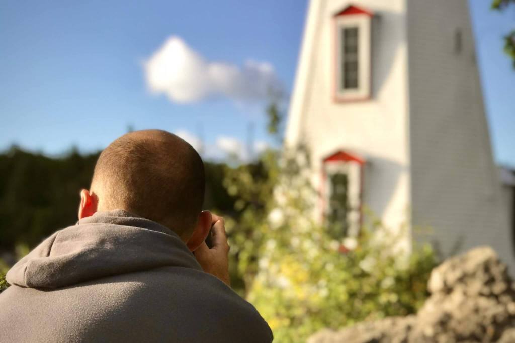 Taking a photo of a lighthouse in Tobermory, Ontario