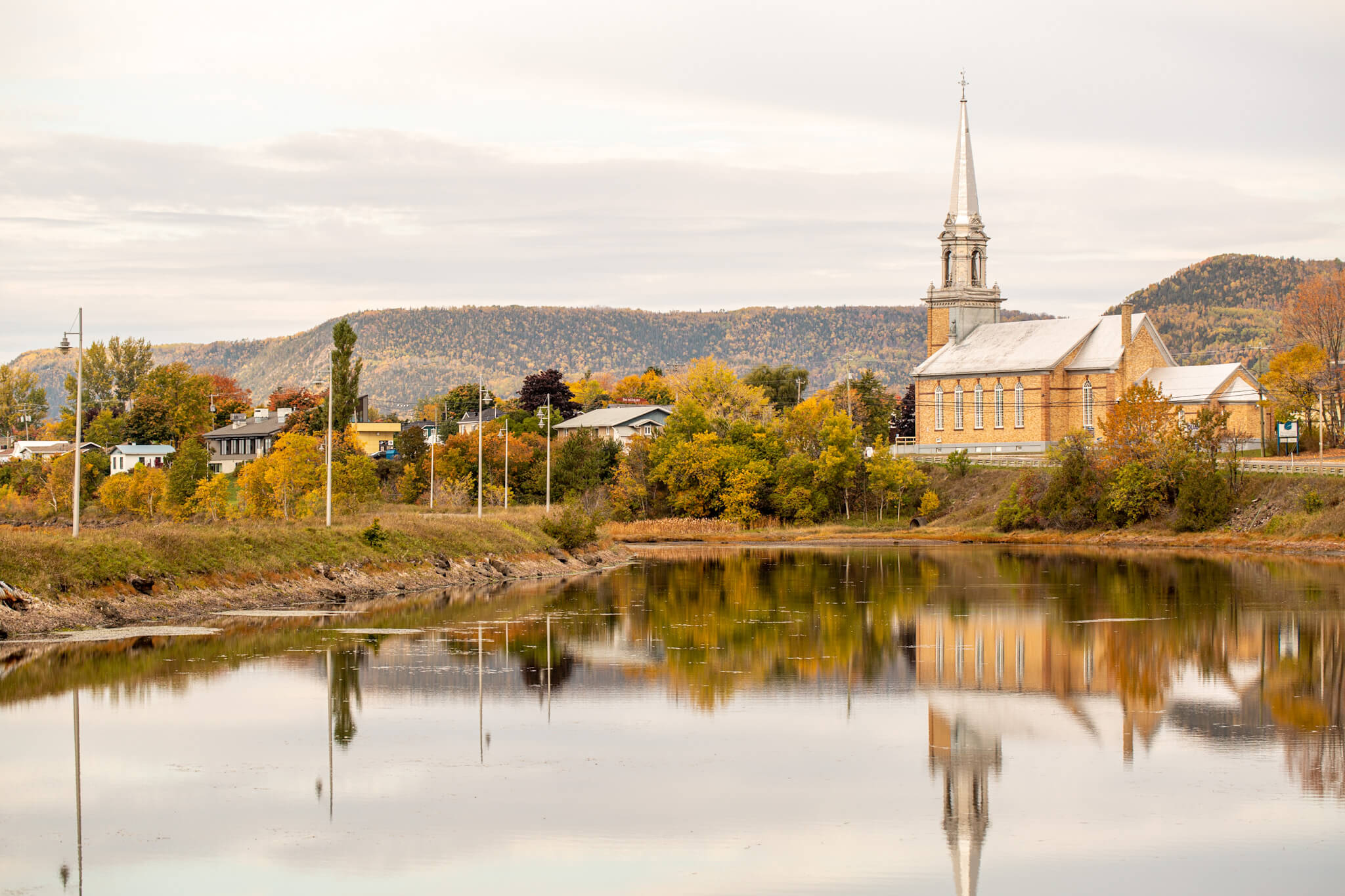 A church reflected on the water in Carleton-sur-Mer, Quebec