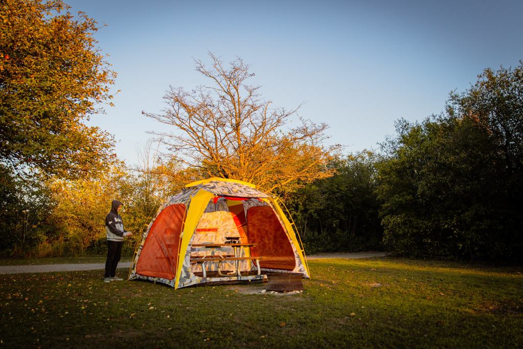 Assembling The North Face Homestead camping shelter over a picnic table