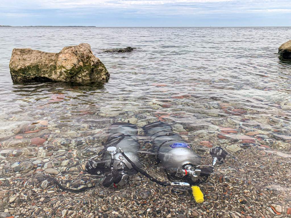 Two sidemount tanks below the water surface before a dive in Humber Bay Park West, Toronto
