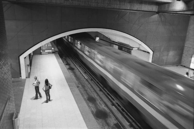 Square-Victoria subway station interior with departing train