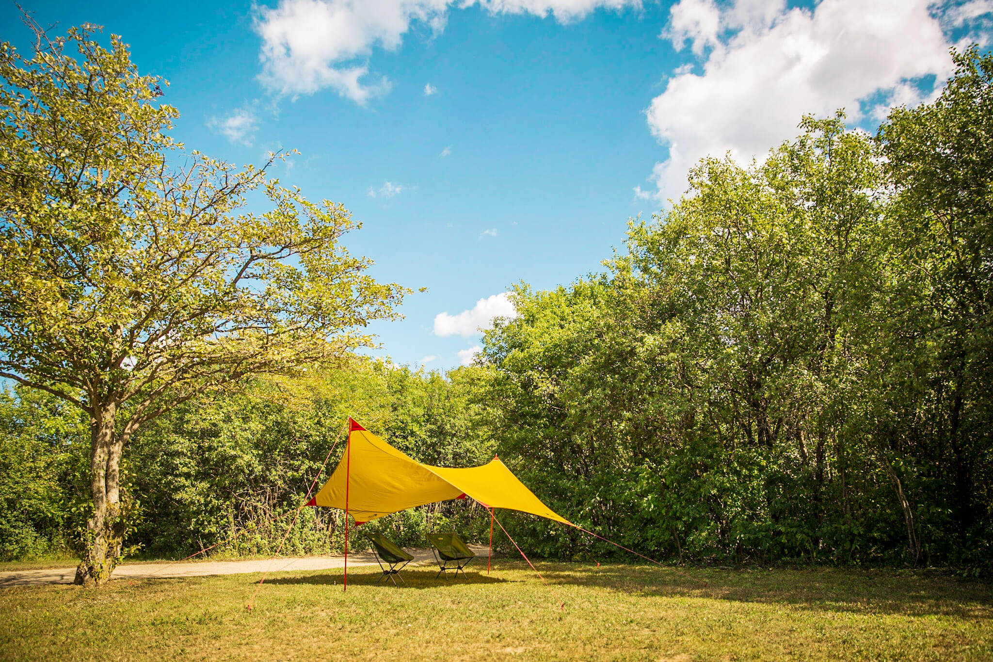 The MSR Rendezvous Sun Shelter 120 creating shade on a campsite
