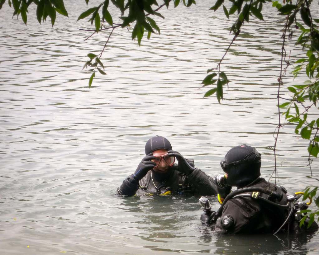 Scuba divers (us!) in drysuits before the dive at Capo d'Acqua