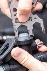 Using the Pandora Tool v3 multitool to unscrew a K-type inflator