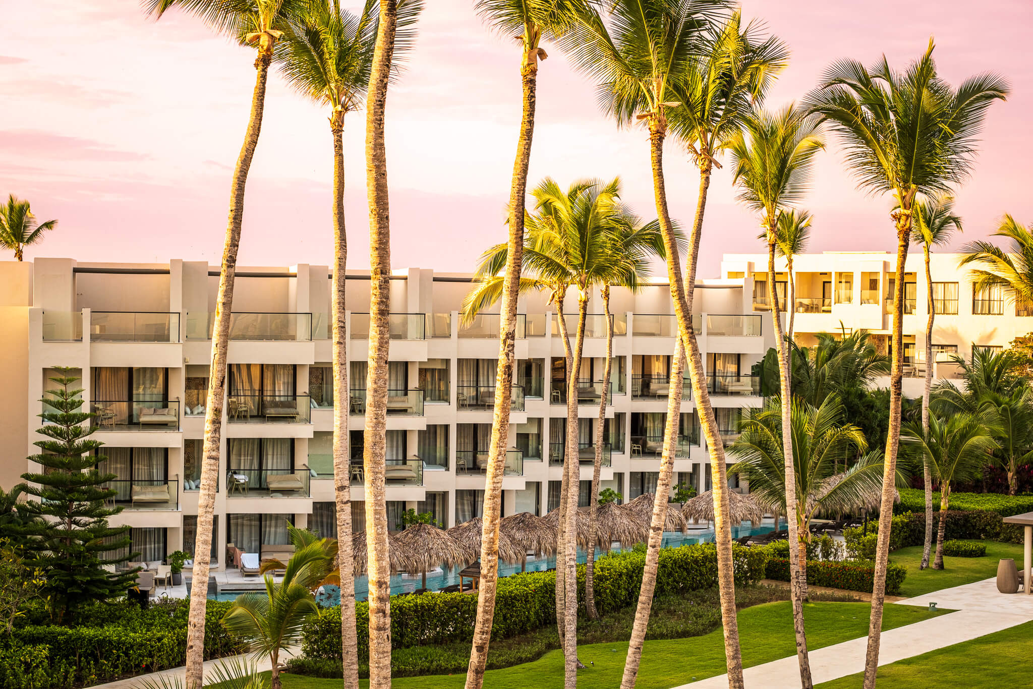 Palm trees in front of resort suite buildings at Excellence El Carmen