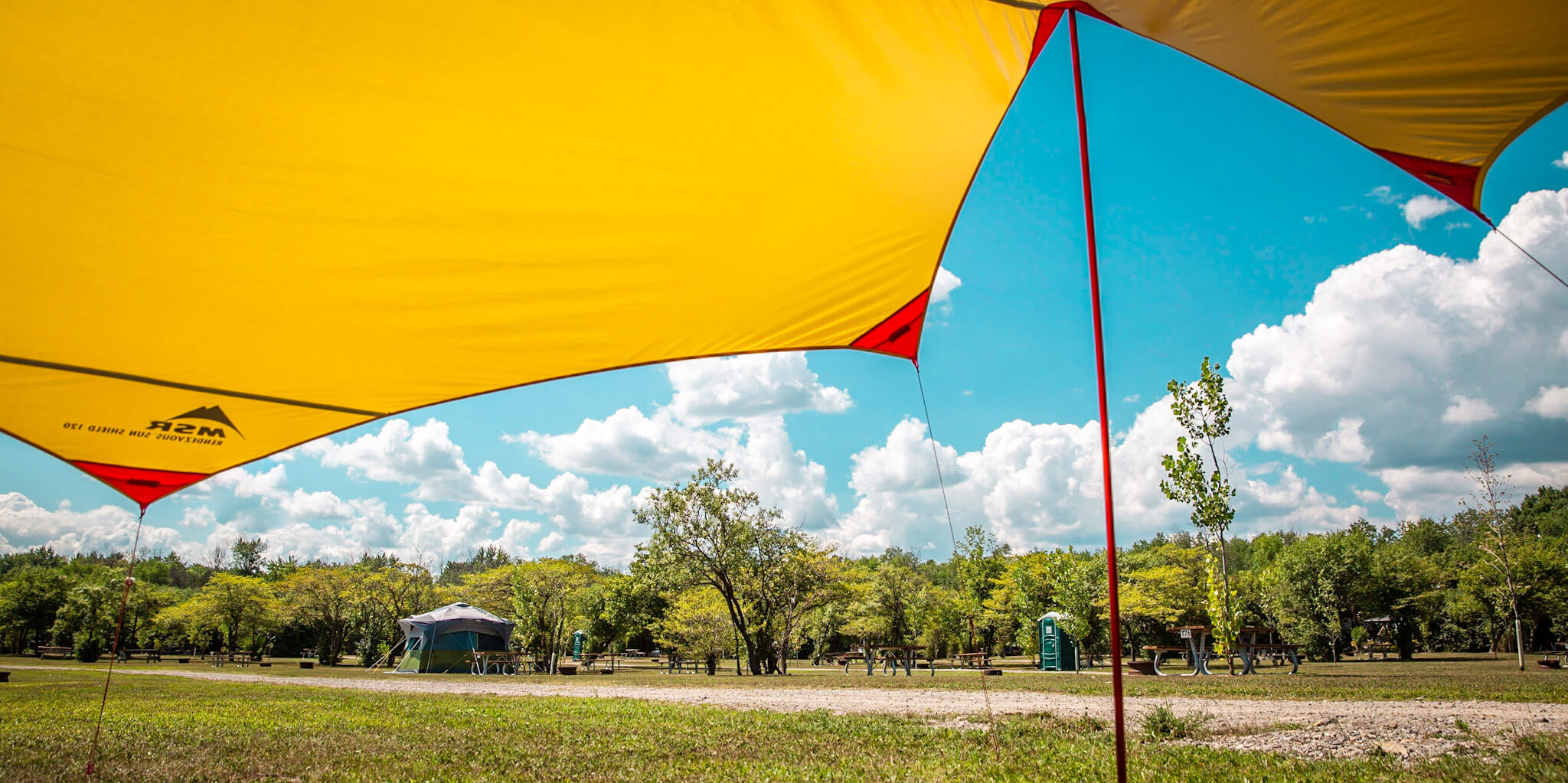 View of a campsite from under the MSR Rendezvous Sun Shield