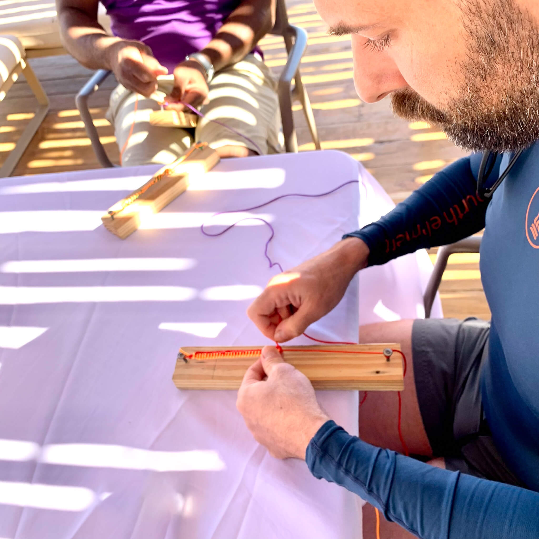 Making a bracelet with the activities team at Excellence El Carmen