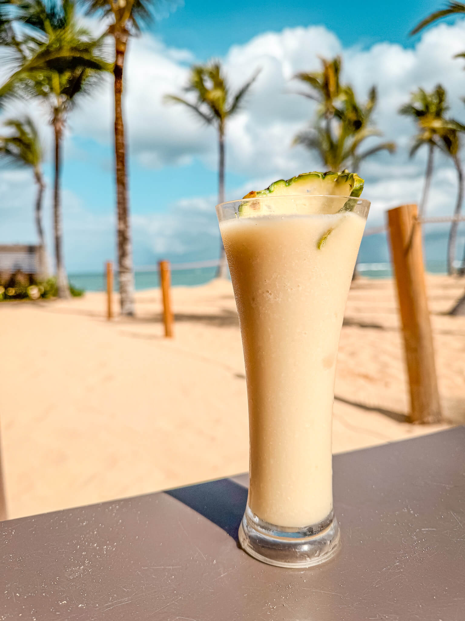 Piña colada on the beach at Excellence El Carmen