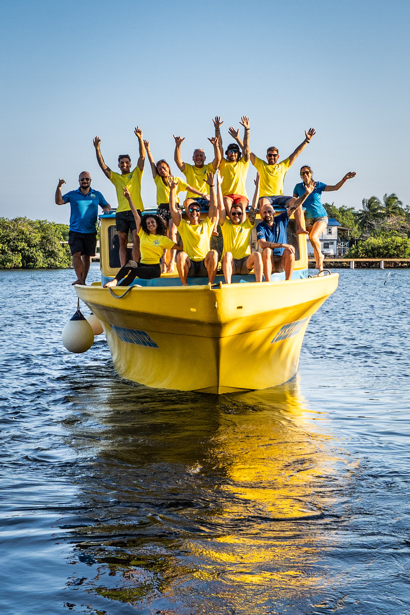 Our March 2025 IDC team celebrating our graduation on a Utila Dive Center boat