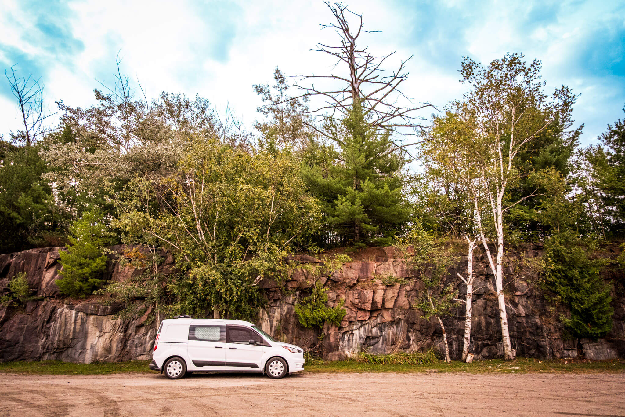 A Transit Connect camper van at an RV spot in Bala, Ontario