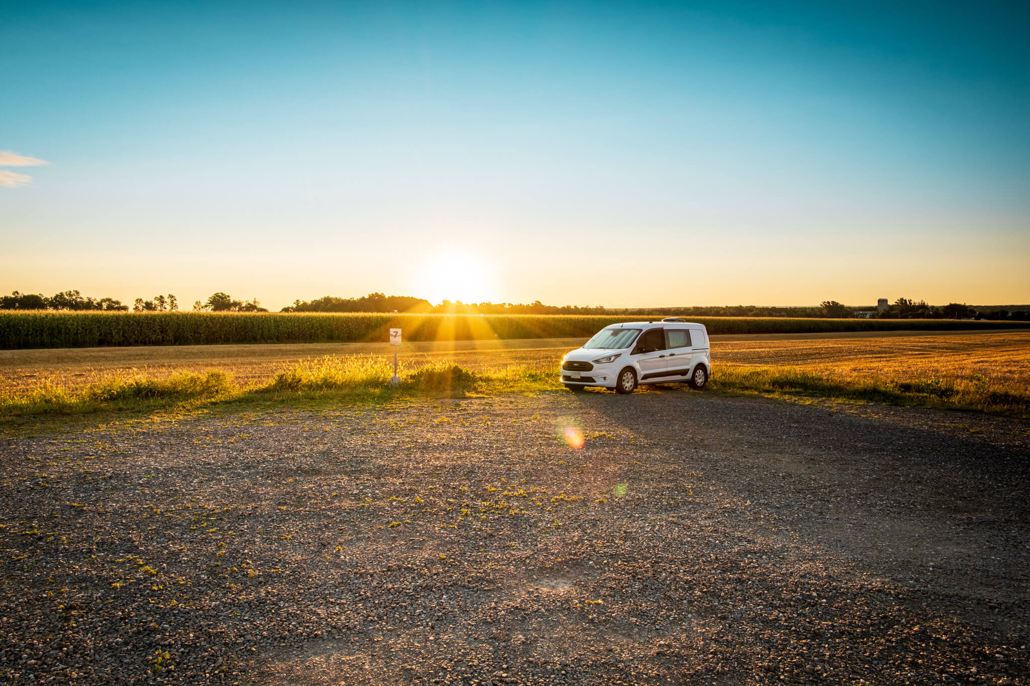 Ford Transit Connect camper van at sunrise at the Berthier-sur-Mer RV stop