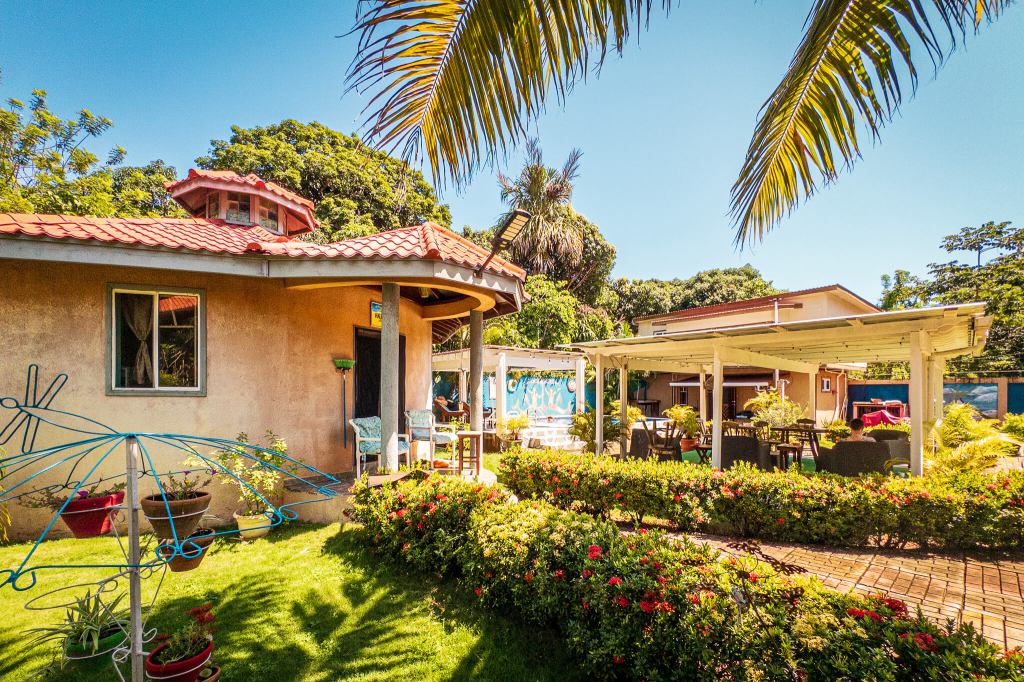 A cabin nestled in a lush tropical garden at Anchor Inn Cabins in Utila, Honduras