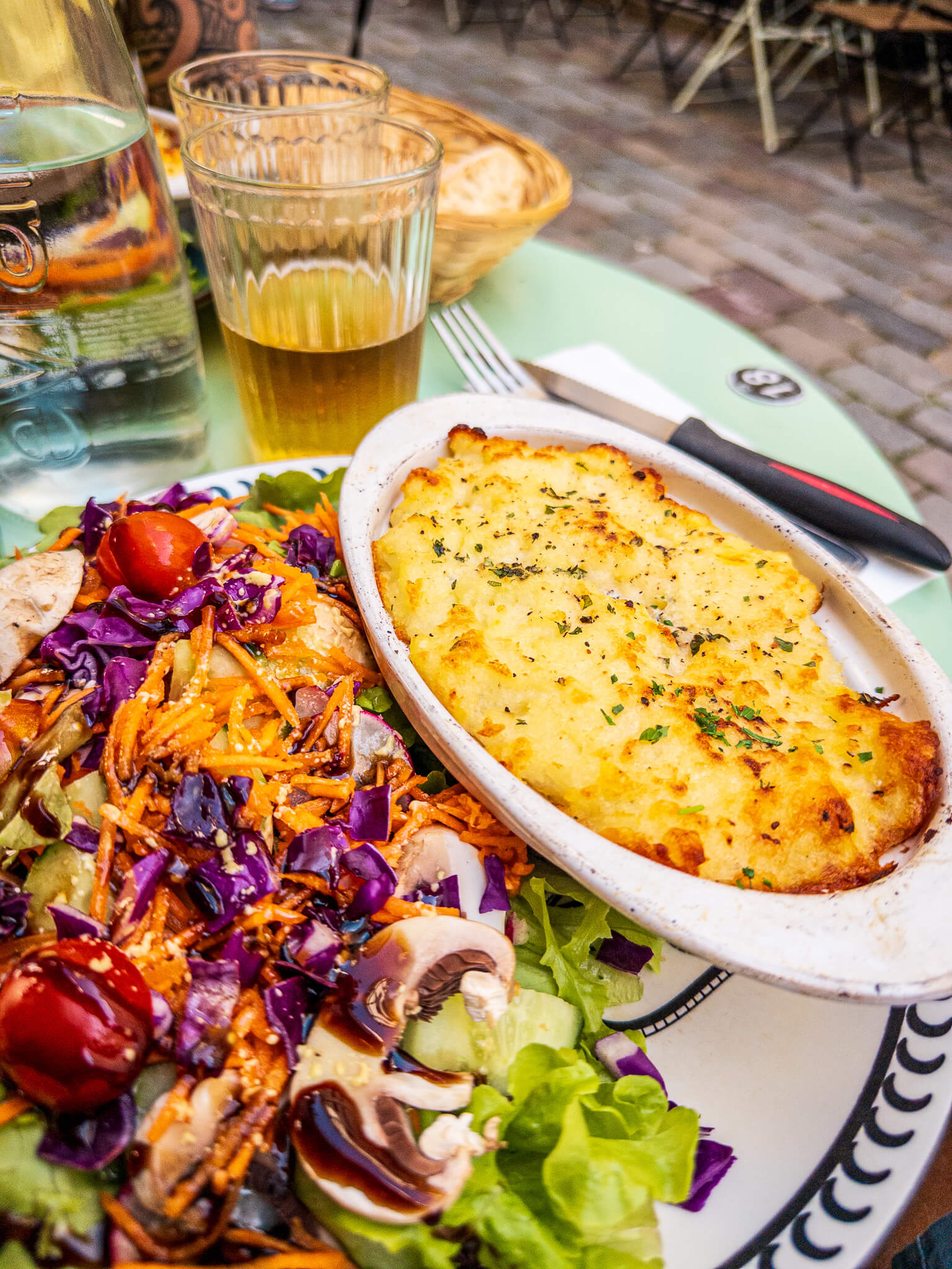 A lunch table at Bistrot Caché in Village Saint-Paul featuring parmentier au canard confit and a salad