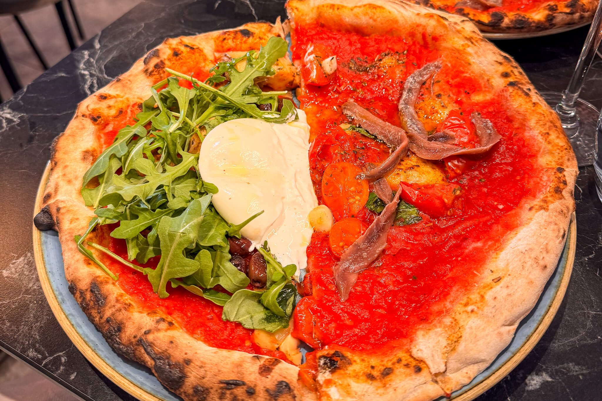 Sharing a burrata pizza and an anchovy pizza at Guillaume Grasso's La Vera Pizza Napoletana in Paris