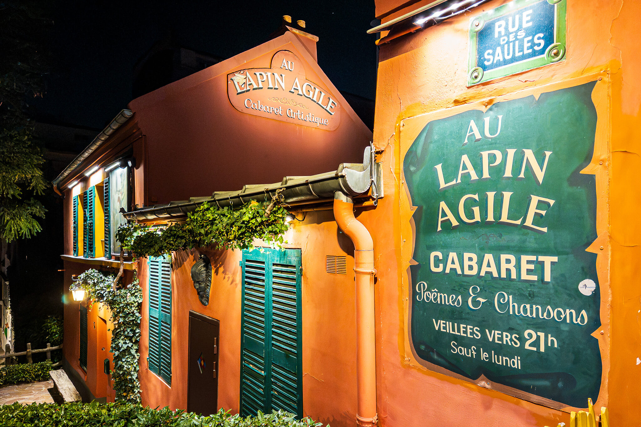 The exterior of Au Lapin Agile cabaret in Montmartre, Paris at night