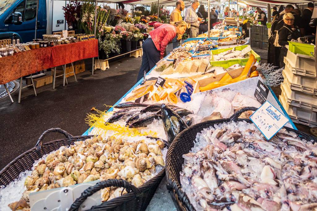 A fish vendor at Marché Raspail in Paris