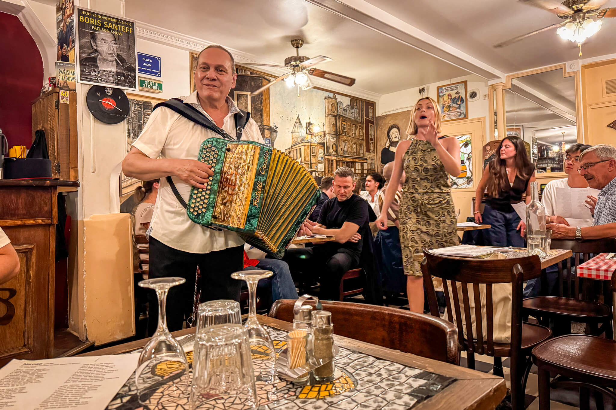 An accordionist and singer performing Edith Piaf songs at Le Vieux Belleville restaurant in Paris